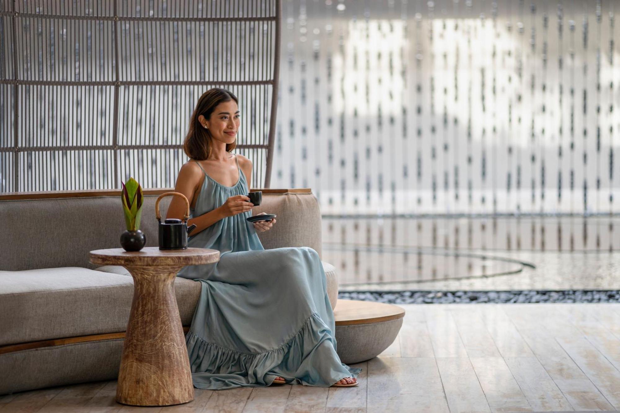 Renaissance Bali Nusa Dua Resort Exterior photo A woman drinking tea